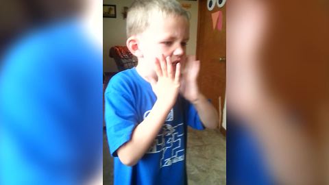 A Young Boy Eats A Piece Of Warhead Candy For The First Time