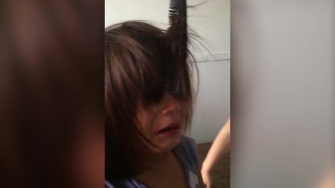 "A Young Girl Cries Because A Comb Is Stuck in Her Hair"
