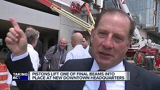 Pistons lift one of the final beams into downtown headquarters