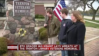 8th grader Ian Kram lays wreath at Trenton Library Veterans Memorial