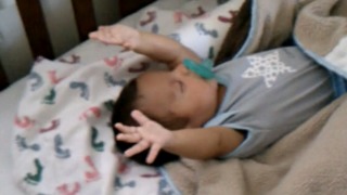 Baby Boy Raises His Arms As He Sleeps