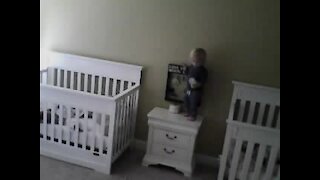 Check out this baby ninja's moves as he climbs into his twin's crib