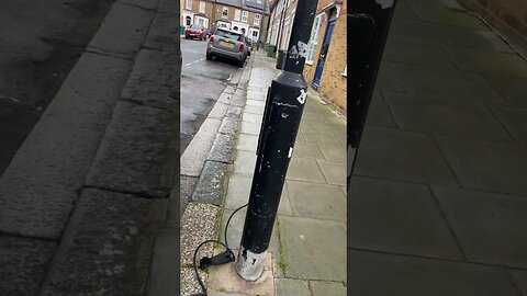 CAR PLUGGED INTO LAMPOST