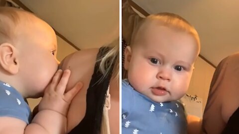 Baby Adorably Mesmerized By Mom's Colorful Tattoo