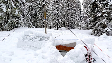 Winter Camping In Snow Shelter During A Storm