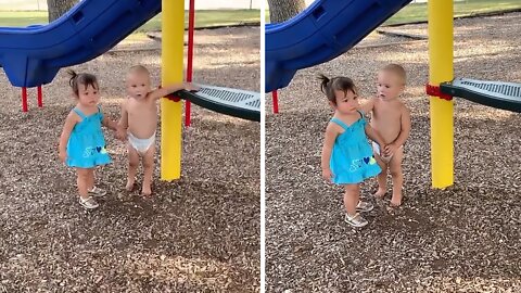 Sweet Baby Boy Holds Hands With Little Girl at the Park