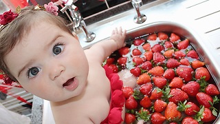 baby eating strawberry