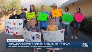 People showing support for Telegraph Fire crews using posters