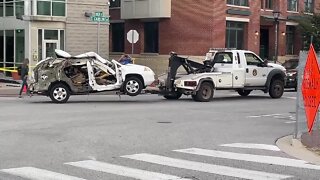 Car involved in parking garage explosion towed out