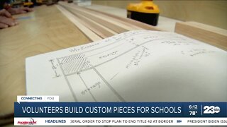 Volunteers build custom pieces for schools