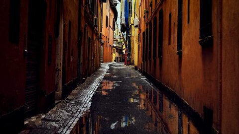 Rain in puddles of a narrow back street of beautiful Bologna