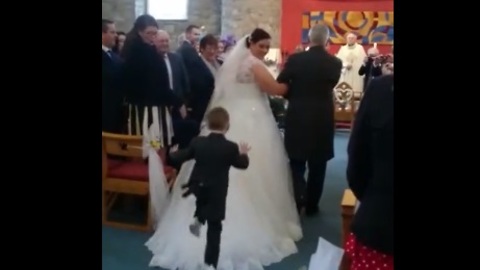 Kid Dives Onto Back Of Bride's Wedding Dress During Ceremony