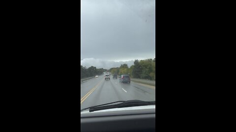 A motorist has filmed an enormous gathering of what appears to be clouds suspended beneath the sky.