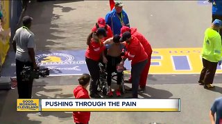 Marine from Tallmadge crawls across the Boston Marathon finish line