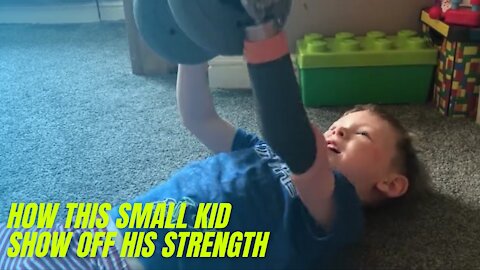 Kid shows off his strength and his father support him