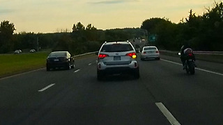 Impatient tailgating car cuts over 2 lanes almost hitting motorcycle.