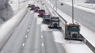 Snow fighters use synchronized snow plowing technique to clear highway
