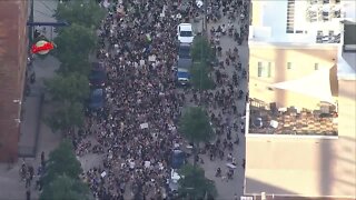 Protesters march outside of Coors Field for George Floyd