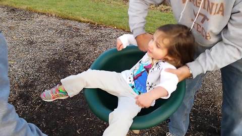 Toddler Girl Can’t Stand Up After Spinning In A Seat On A Playground