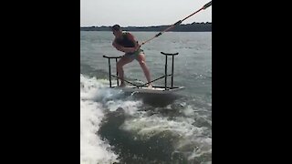 Guy water skies on top of folding table