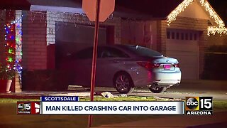 Man killed crashing car into garage