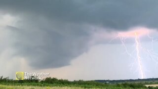 Huge bolt of lightning strikes the horizon ahead of storm clouds