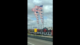 8 flags on one flagpole at siemonds in Dallas Texas