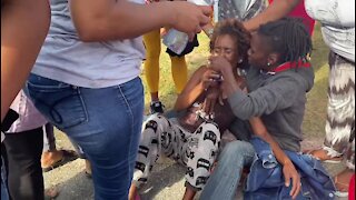 UPDATE 1 - WATCH: Emotional residents gather outside Tazne's home following discovery of corpse (kWQ)