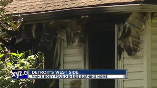 Man's body found inside burning home