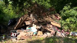 Neighbors tired of looking at trash illegally dumped on property