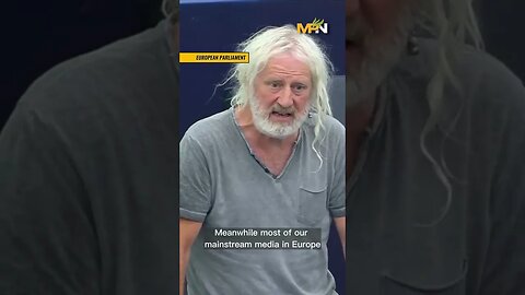 Mick Wallace stands with Julian Assange