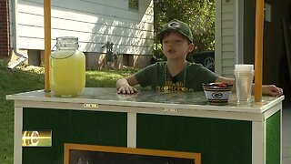 Young boy sets up lemonade stand near Lambeau