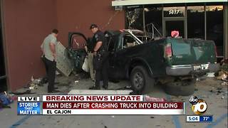 Man dies after crashing truck into building
