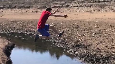 Boy Makes Huge Jump Across Stream, Lands in Mud and Loses Shoes