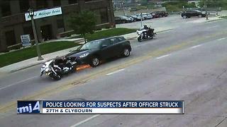 Police looking for suspects after officer injured in hit-and-run