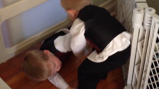 A Little Boy Gets Stuck Underneath A Gate At Home