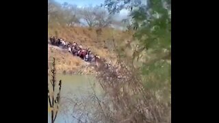 Smugglers Illegally Ferry A Huge Line Of People Across Rio Grande To US