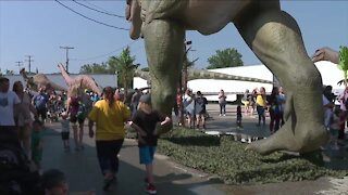 Guests walk amongst the dinosaurs at Cuyahoga County Fairgrounds