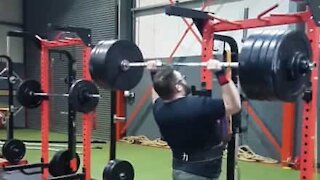 Strongman falls backwards doing overhead press