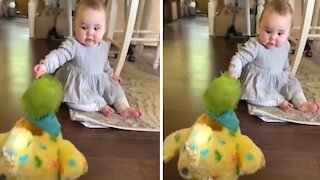 Baby utterly shocked at toy hen laying eggs