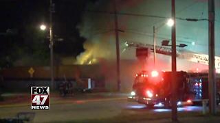 Crews battling fire at local party store