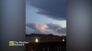 Lightning-filled cloud hovers over neighbourhood