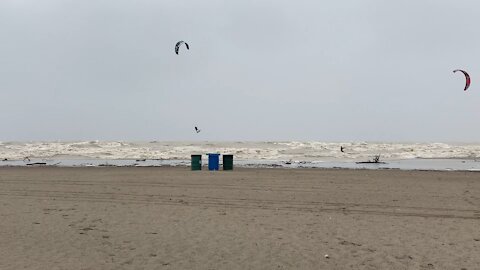 Amazing wind surfers play in the storm