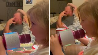 Dad Has Priceless Reaction When Daughter Sings Into Microphone