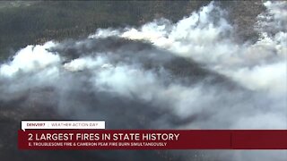 Two of the state's largest wildfires are burning simultaneously