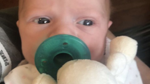 Newborn baby adorably sneezes on camera