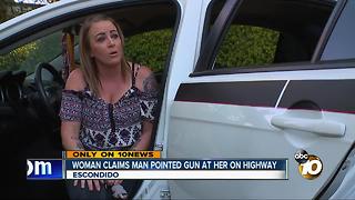 Woman claims man pointed gun at her on highway