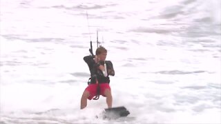 Kitesurfers enjoy the waves at Juno Beach ahead of Isaias