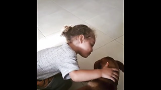 Little boy gives his dog sweet kiss