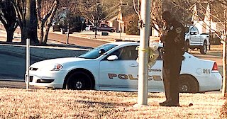 School Resource Officer Prays At Flagpole